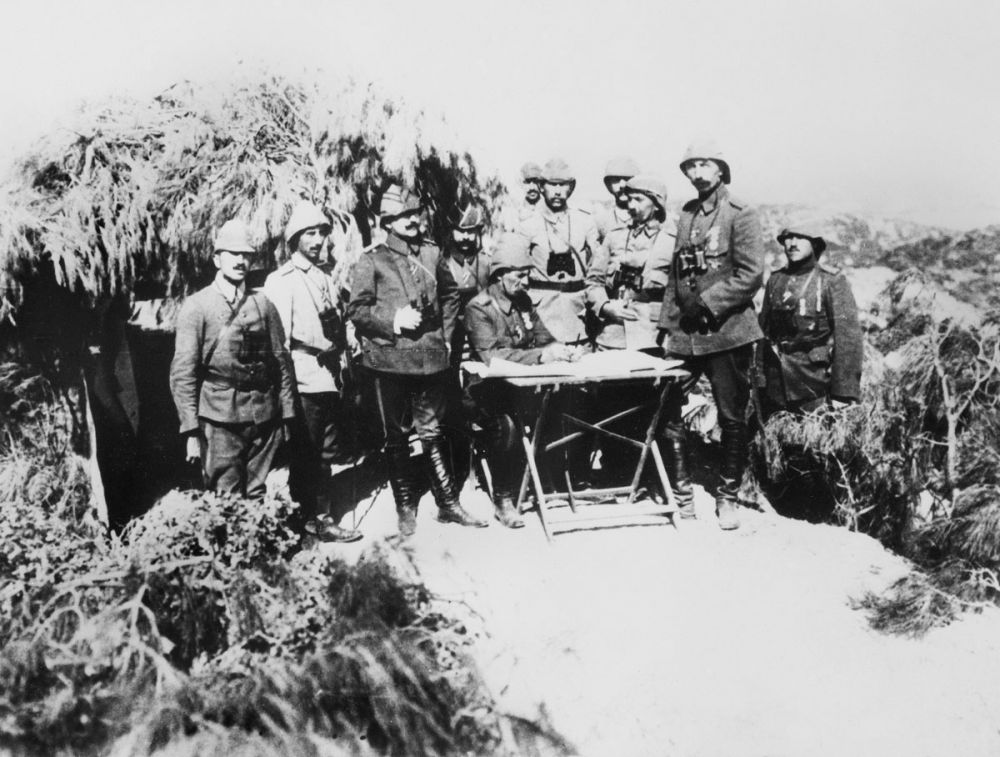Essad Pasha, corps commander of the Turkish forces, holds a conference with his staff on a hill overlooking the battlefields.